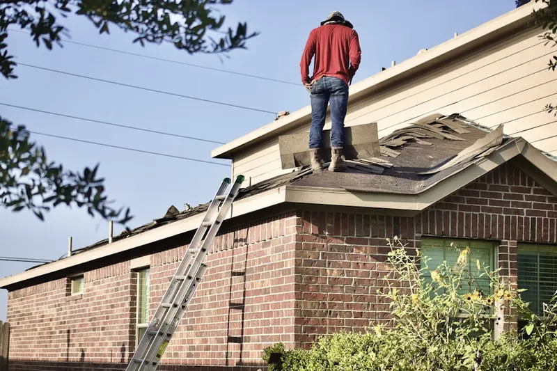 Professional roofer working on a residential roof in Palmcroft